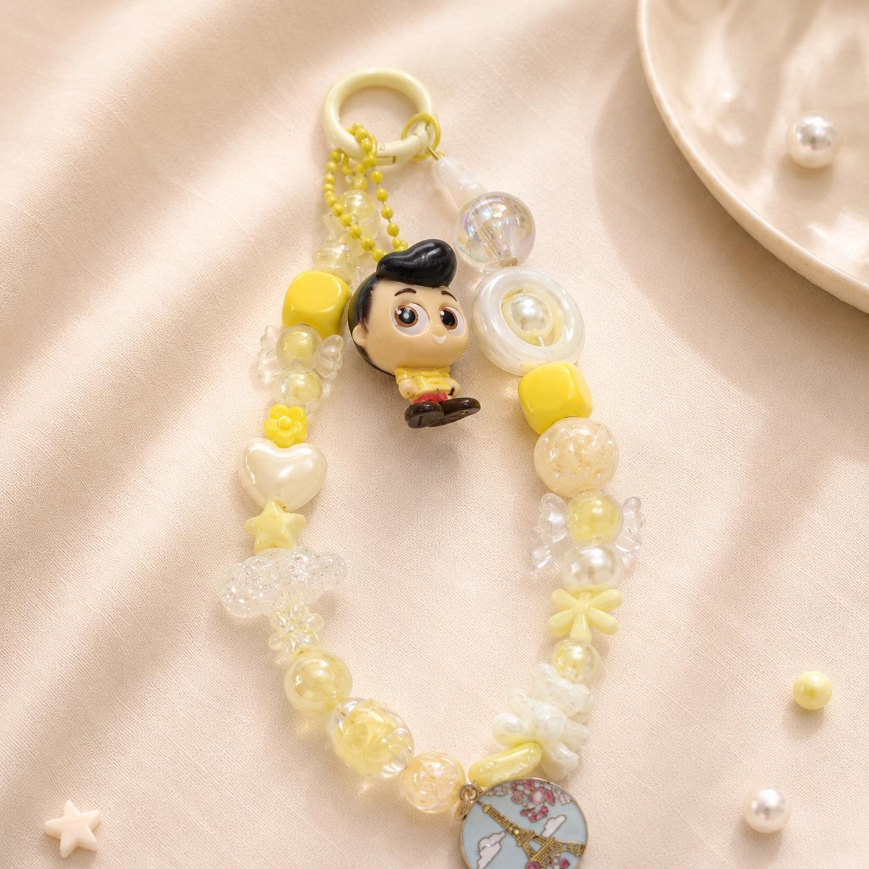 Porte-clé Kawaii jaune avec figurine personnage et charm tour Eiffel